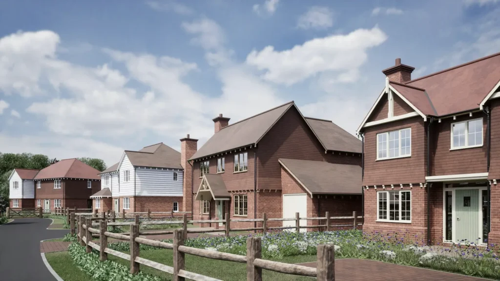Newly built red-brick homes facing a freshly surfaced estate road with timber post-and-rail fencing